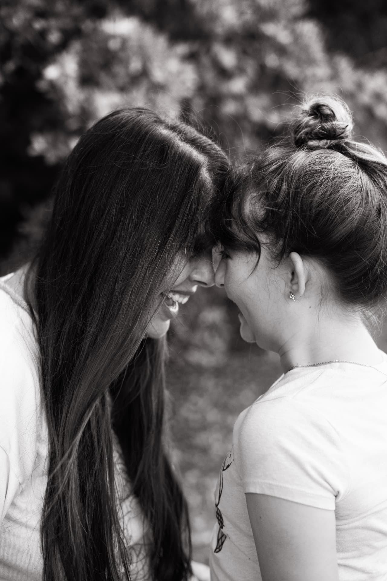 Heather and her daughter forehead to forehead, laughing
